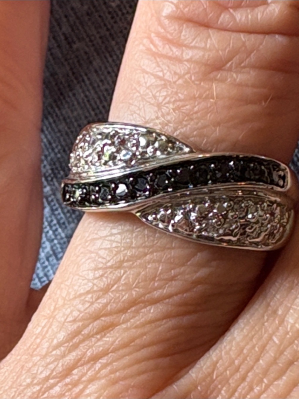 Size 8.5 woman’s bypass ring with Black and Clear Stones. Unknown metal